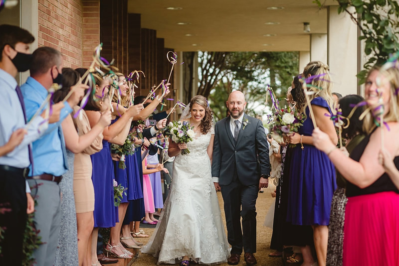 bride and groom walking hand in hand through tunnel of wedding guests + Memphis, TN wedding