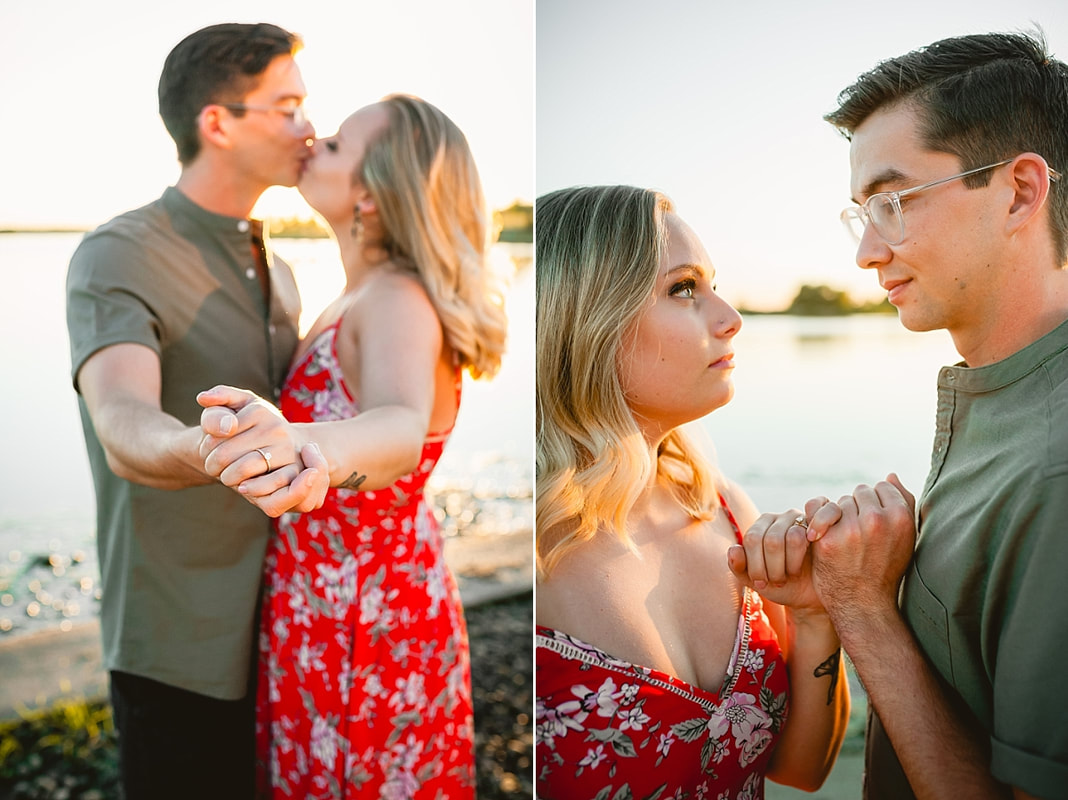 couple posing for engagement photos by the lake at shelby farms park in memphis, tn