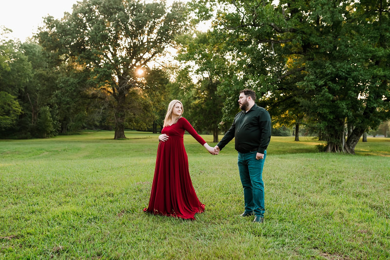 mother and father posing for maternity photos at Shelby Farms in Memphis, TN