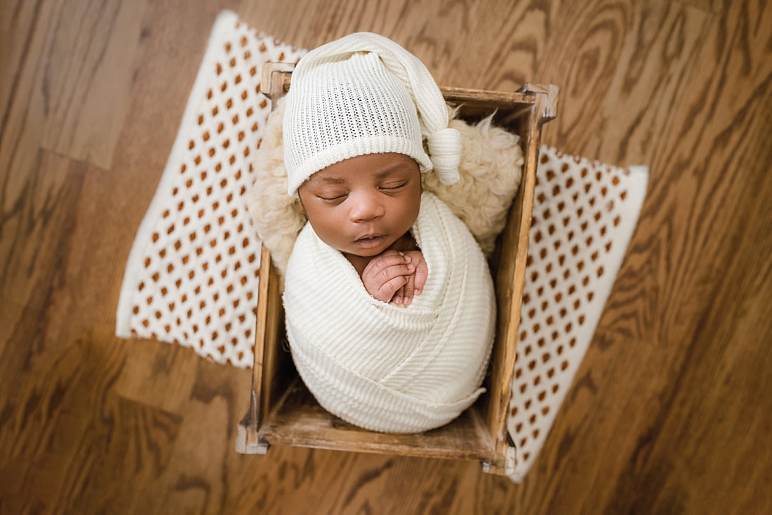 newborn baby sleeping in wooden box for newborn session with sarah morris photography