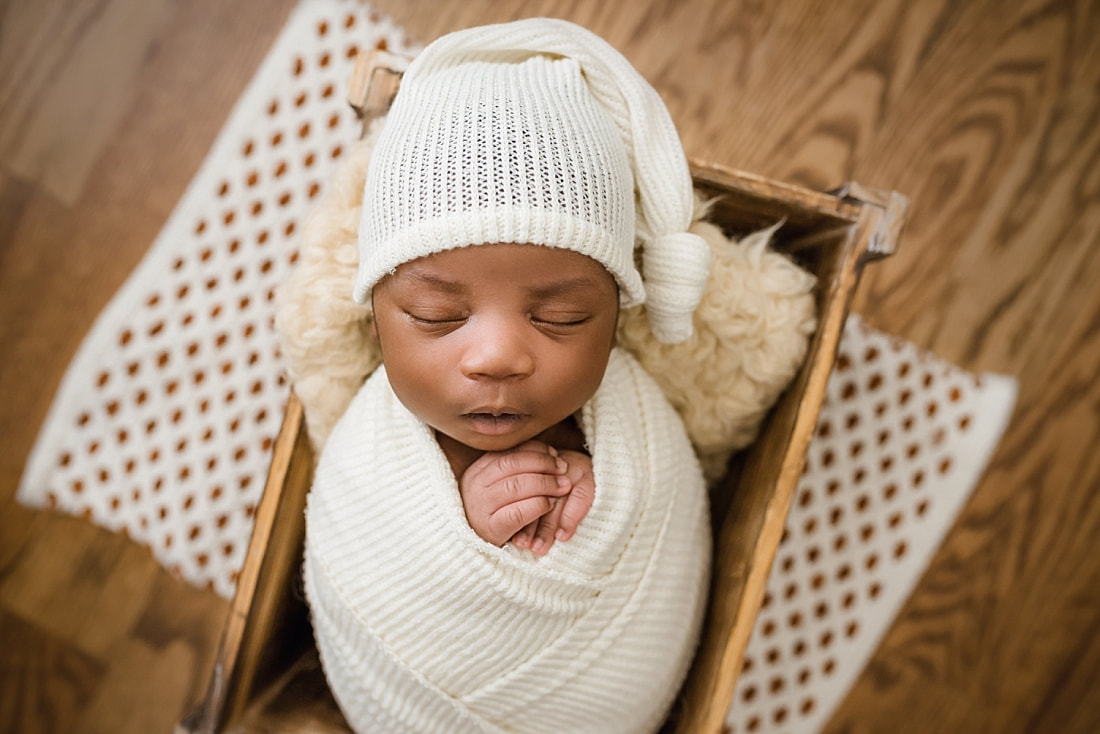 newborn baby sleeping in wooden box for newborn session with sarah morris photography