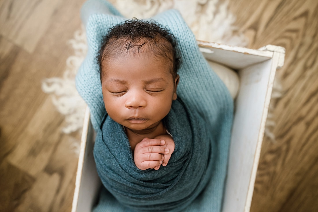 newborn baby sleeping in wooden box for newborn session in Memphis, TN