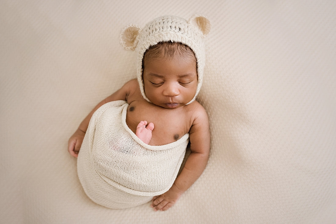 newborn baby wearing teddy bear bonnet for newborn photos in Collierville, TN