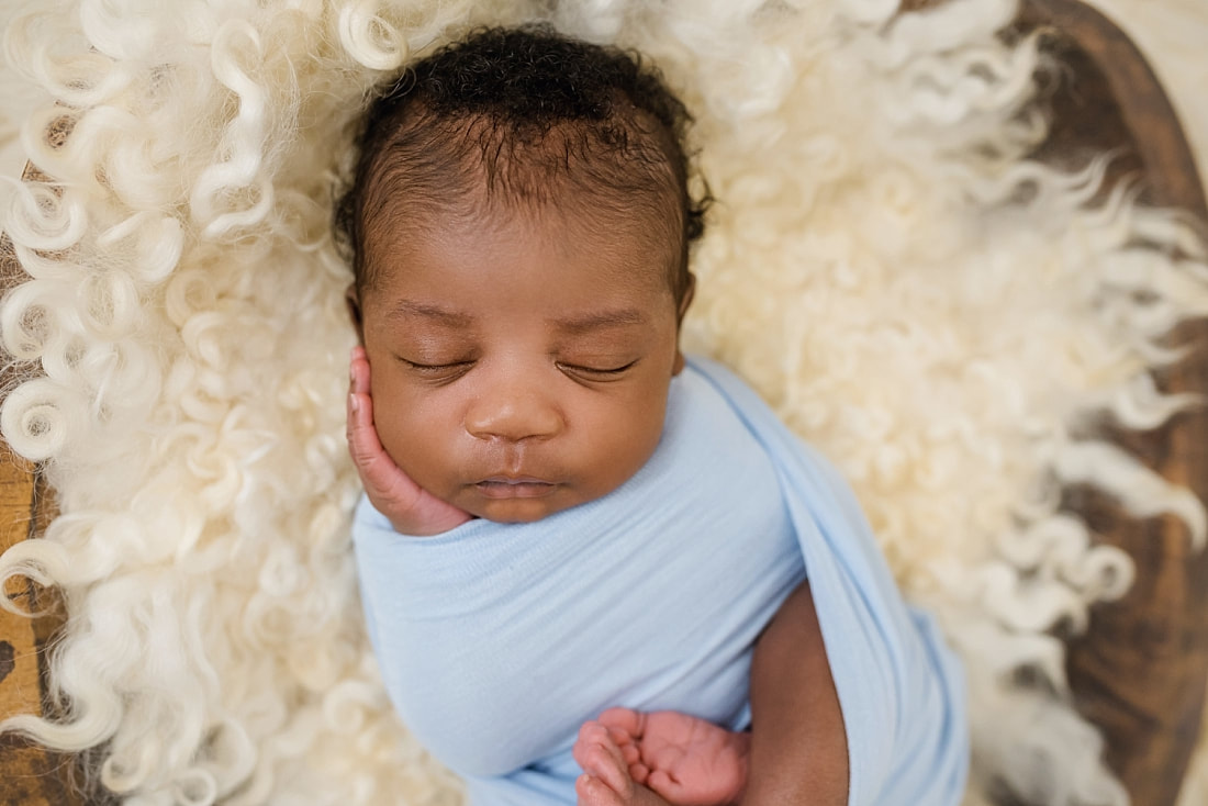 Picture of baby boy swaddled in blue blanket in Collierville TN