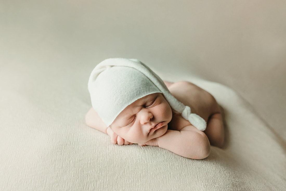 newborn baby boy posed and sleeping on tan blanket in Memphis, TN