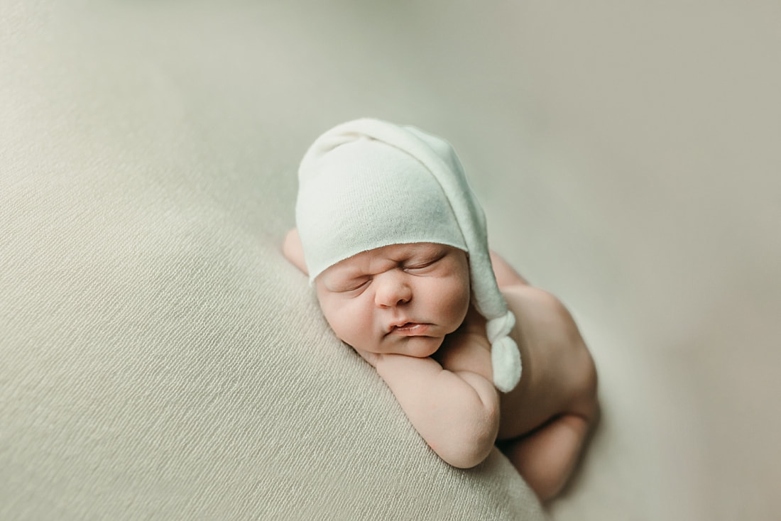 newborn baby boy posed and sleeping on tan blanket in Memphis, TN