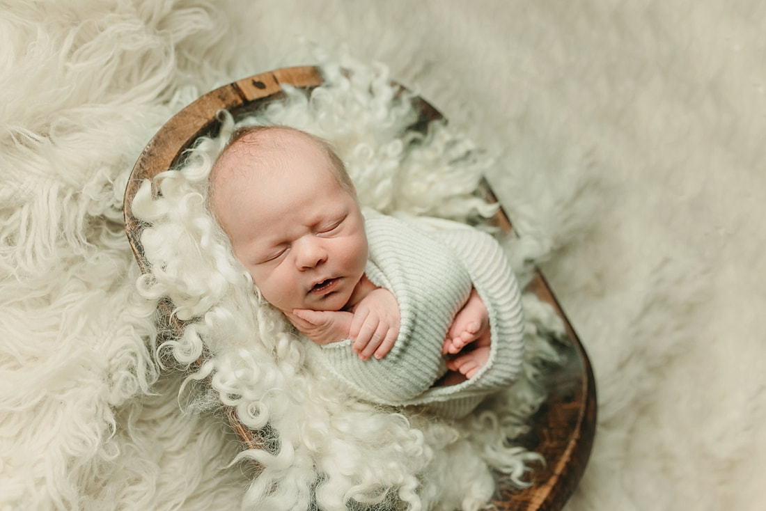 newborn baby wrapped in ivory blanket for newborn portraits in Memphis, TN