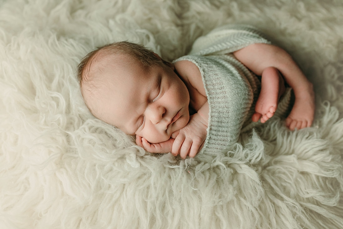 newborn baby wrapped in ivory blanket for newborn portraits in Memphis, TN