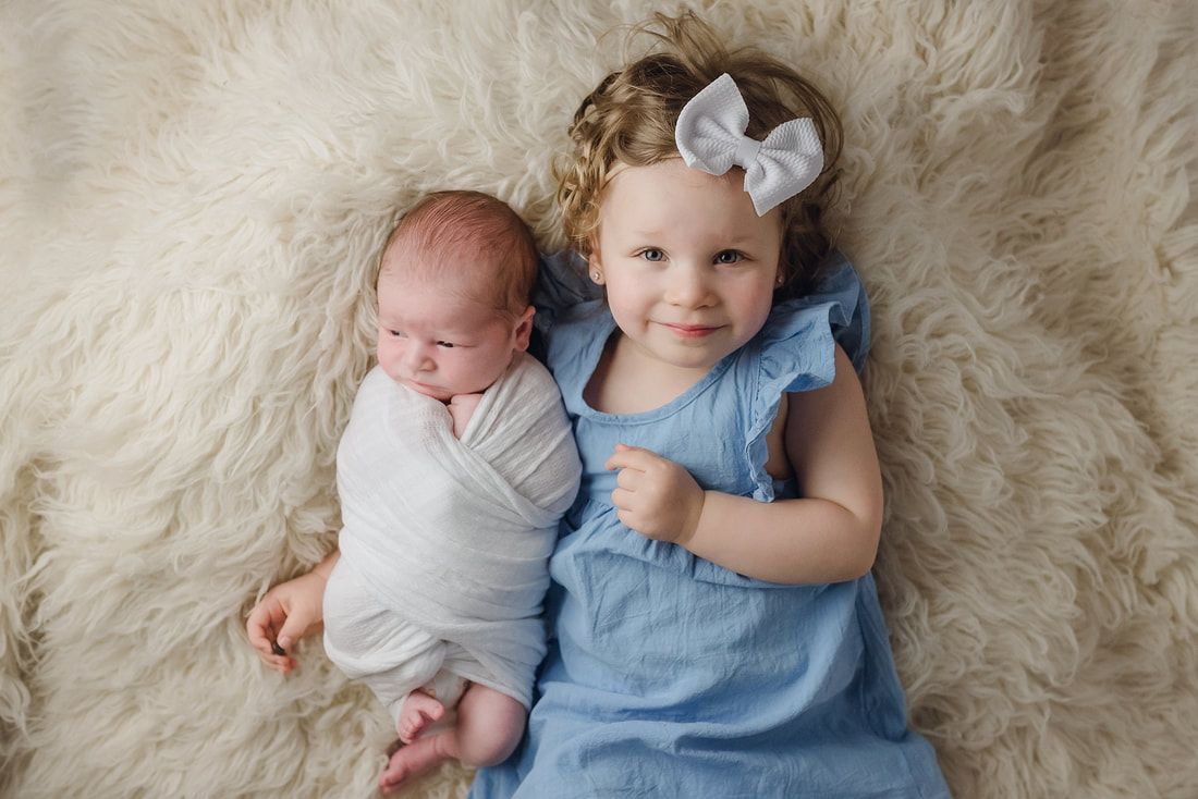 toddler sister with newborn baby brother in Arlington, TN